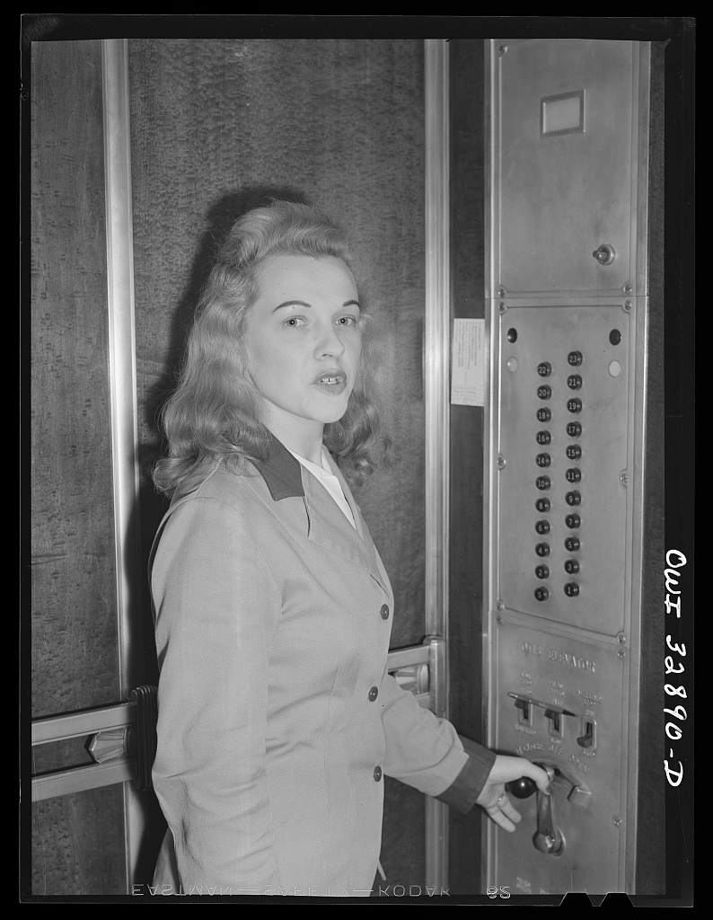 Elevator operator with hand on the control lever, Philadelphia, 1943